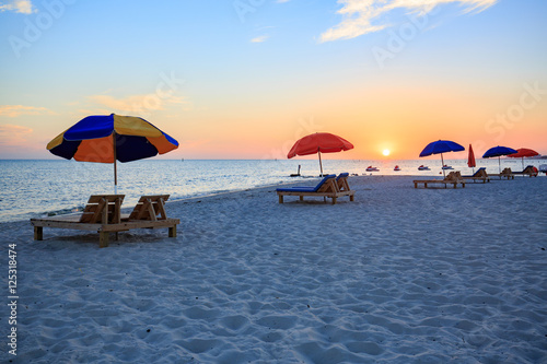 Sunset in Biloxi beach, with umbrella for tourist, Mississippi, along Gulf Coast shore