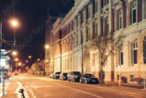 Blurred background - Street night city lights blur. Retro toned photo, Vintage filtered image. © tirachard