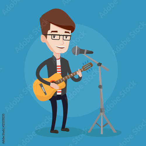 Man singing in microphone and playing guitar.