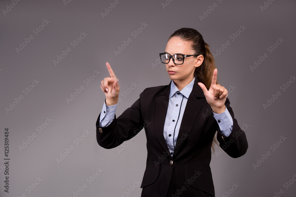 Young woman businesswoman pressing virtual buttons Young woman businesswoman pressing virtual buttons