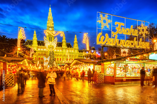 Traditional christmas market with 'Merry Christmas' sign in Vienna, Austria