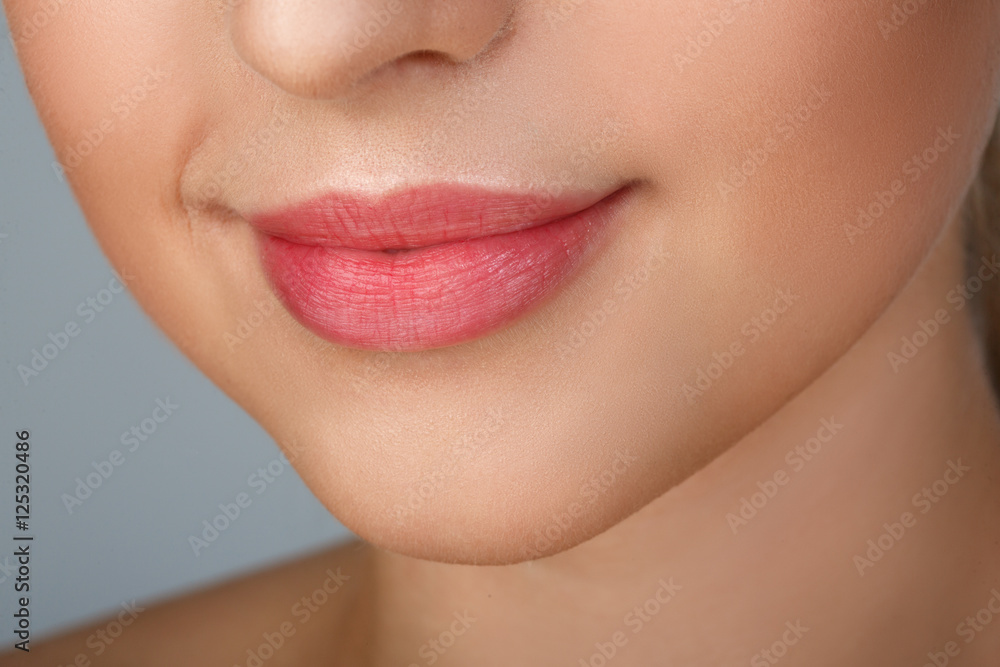 Obraz premium Perfect natural lip makeup. Close up macro photo with beautiful female mouth. Plump full lips. Close-up face detail. Perfect clean skin, light fresh lip make-up. Beautiful spa tender lip