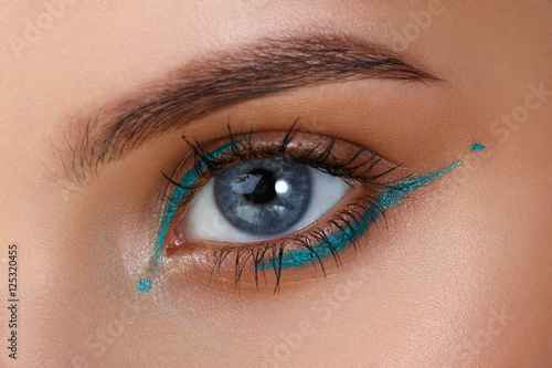 Blue eyes. Eye makeup. Beautiful eyes make-up. Holiday makeup detail. Long eyelashes. Close-up shot of female eye make-up