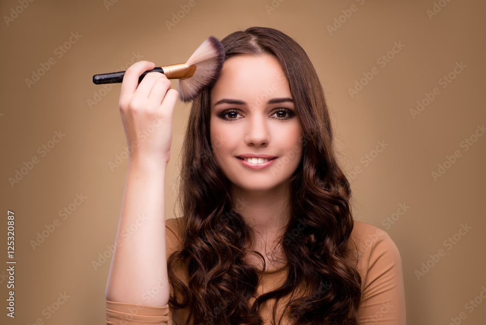 Beautiful woman applying make-up in beauty concept Beautiful woman applying make-up in beauty concept