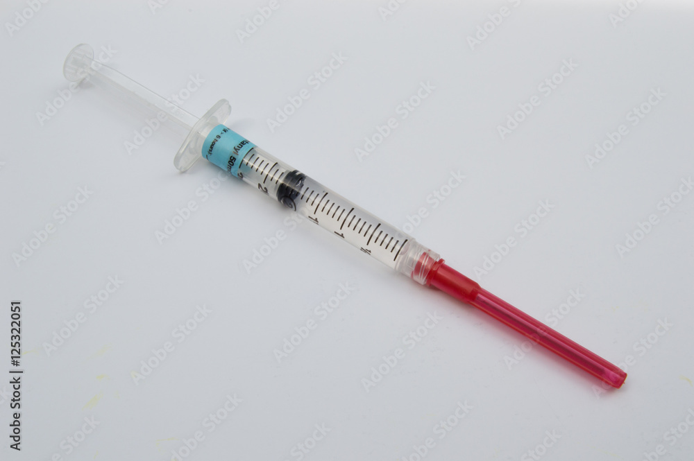 Syringe and Capped Needle Containing Fentanyl on White Background Syringe and Capped Needle Containing Fentanyl on White Background