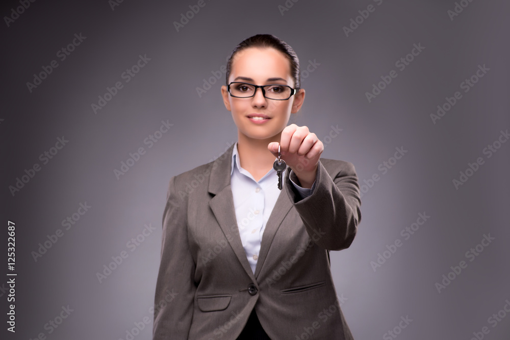 Woman holding keys in housing mortgage concept Woman holding keys in housing mortgage concept