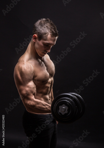side view, profile young bodybuilder arm dumbbell exercise