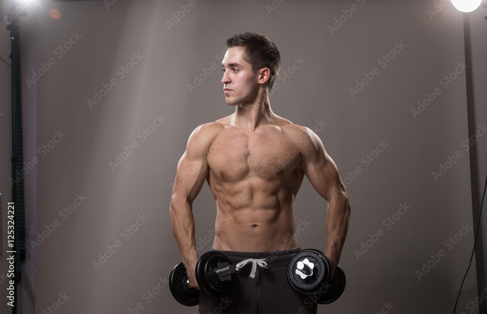 Young bodybuilder posing reflectors in studio. Young bodybuilder posing reflectors in studio.