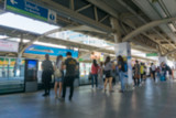 Blurred background.People standing in lines waiting for BTS sky train