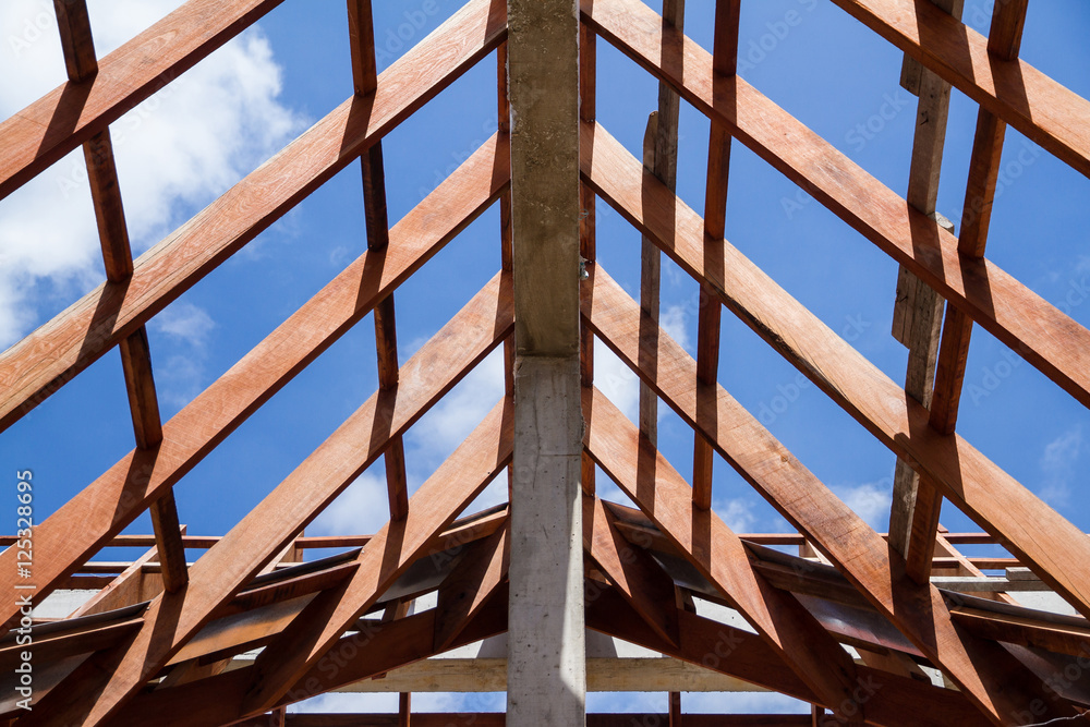 Low angle view of roof trusses and framing wooden of new house c Low angle view of roof trusses and framing wooden of new house c