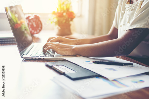 Young business woman hands typing on keyboard to work at office. photo