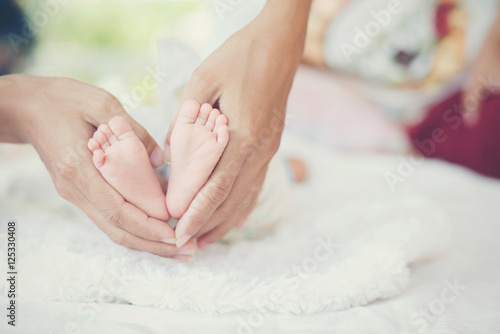 Newbron Baby feet in the mother hands.