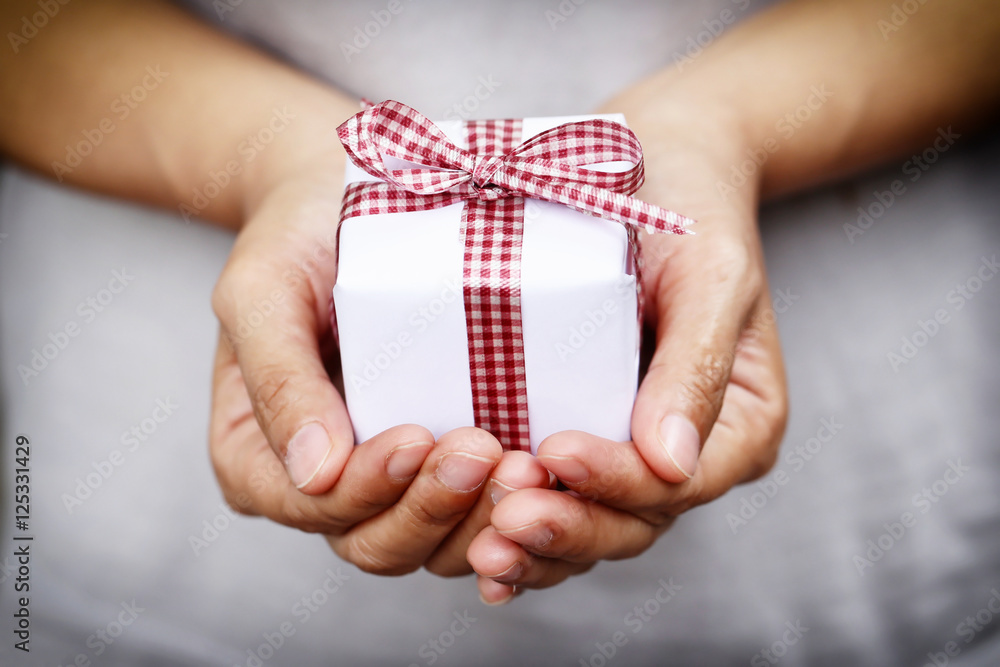 White Gift box on hand and Red Ribbon on gift box,Concept christ White Gift box on hand and Red Ribbon on gift box,Concept christ
