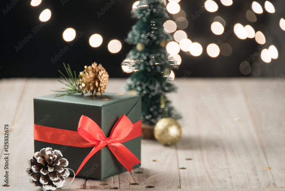 christmas decorations and green present on wood. christmas decorations and green present on wood.