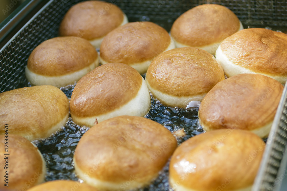 Preparation of donuts. Roasting in boiling oil