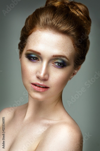 Beautiful woman portrait with red hair and freckles. Glamour make up.