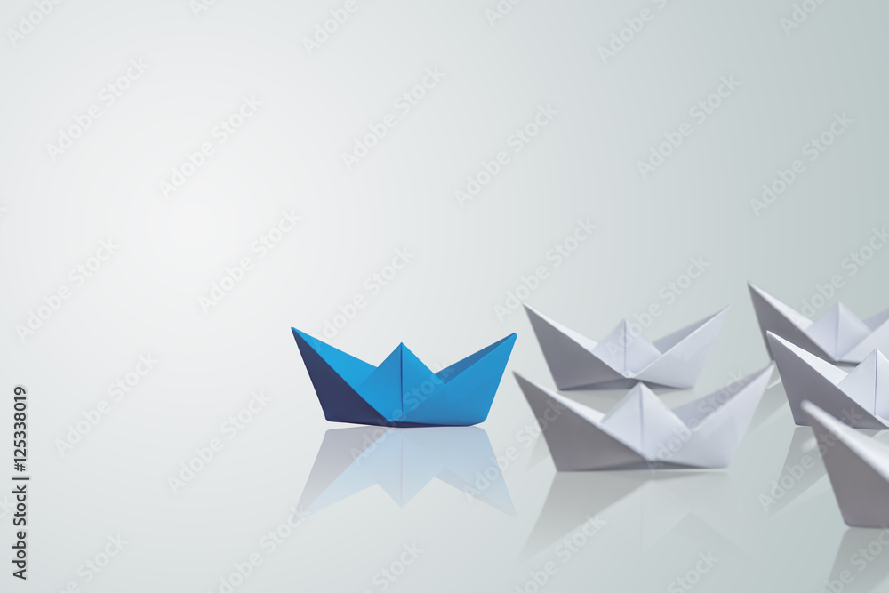 uniqueness concept, paper boat outstanding from the others uniqueness concept, paper boat outstanding from the others