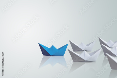 Fototapeta Naklejka Na Ścianę i Meble -  uniqueness concept, paper boat outstanding from the others 