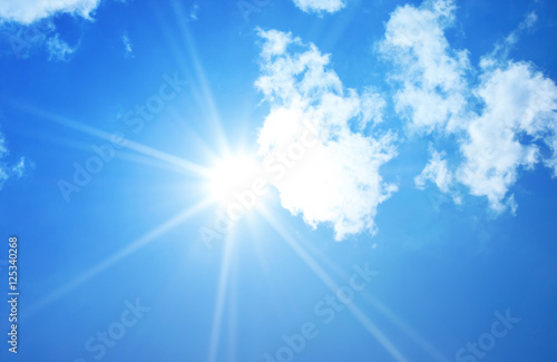 Beautiful blue sky sunbeams and clouds with sun rays nature back