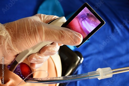 Intubation of rubber head model with modern videolaryngoscope and endotracheal tube photo