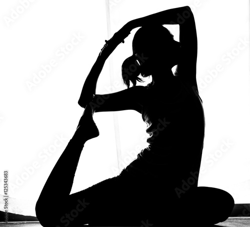 Black and white silhouette yoga woman in Absara pose photo