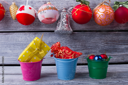 Beautiful colorful buckets with Christmas gifts.