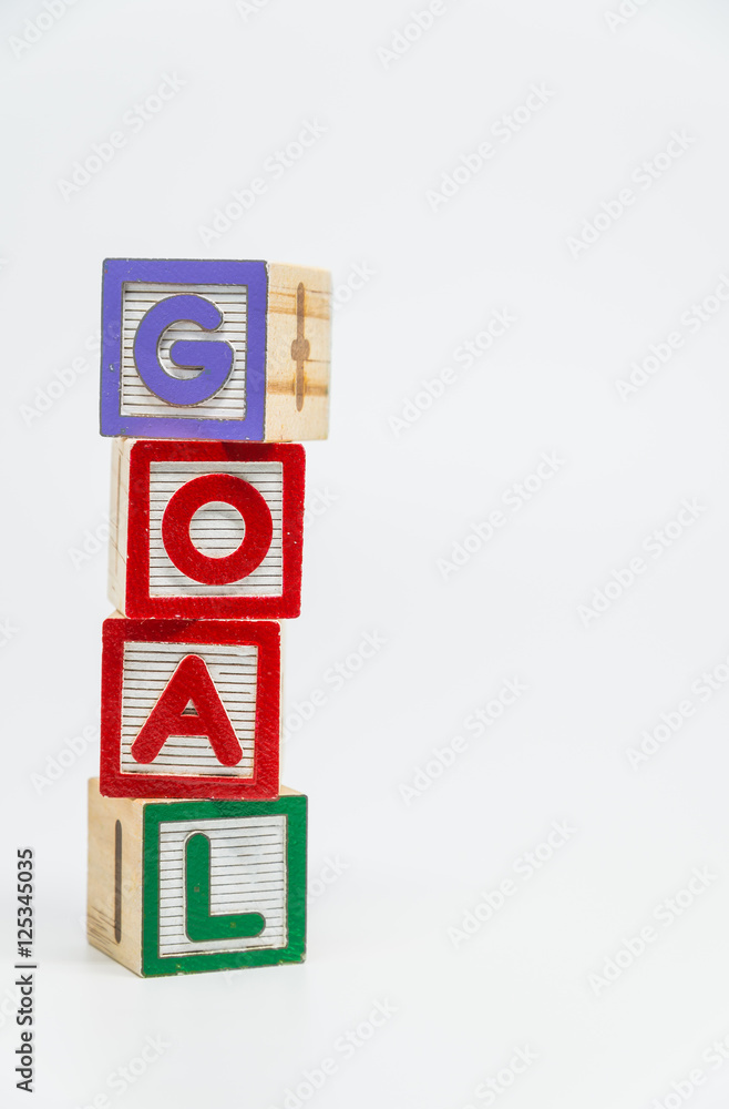 GOAL word wooden block arrange in vertical style on white background and selective focus GOAL word wooden block arrange in vertical style on white background and selective focus