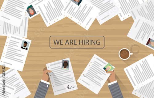 We are hiring written on office desk