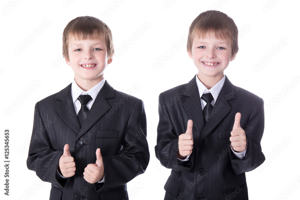 two little boys twins in business suits thumbs up isolated on wh two little boys twins in business suits thumbs up isolated on wh