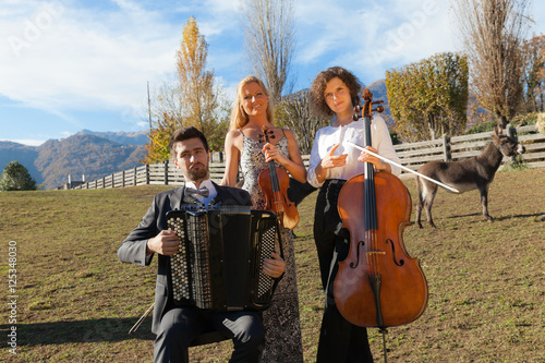 three young musicians, outdoors