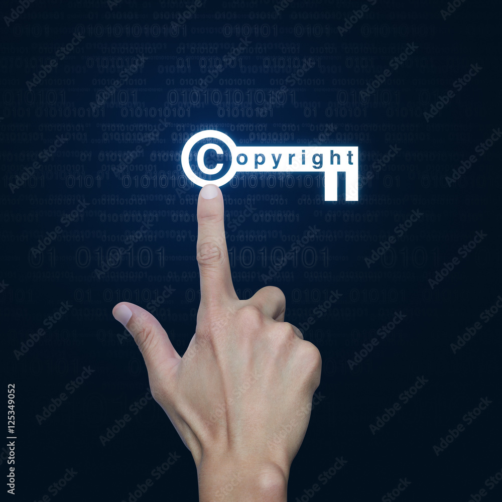Hand pressing copyright key icon over computer binary code blue Hand pressing copyright key icon over computer binary code blue