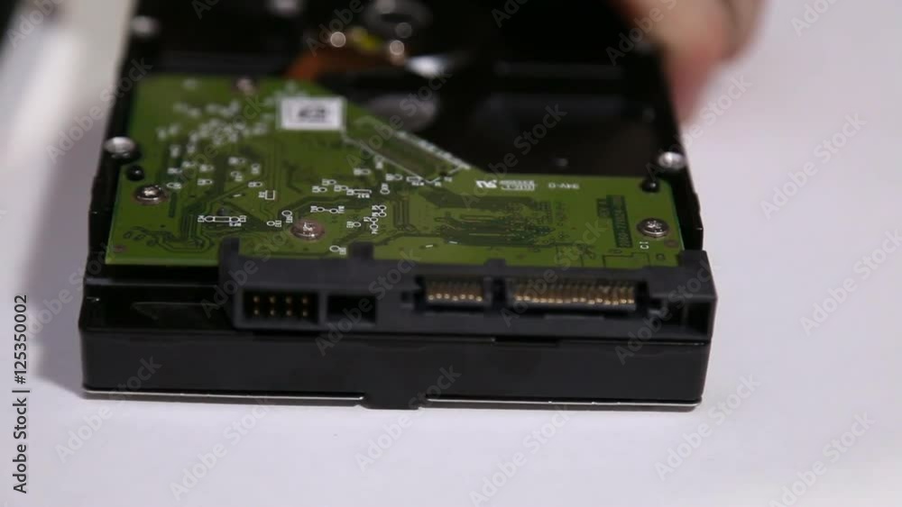 Master unscrews the screw from the hard drive Master unscrews the screw from the hard drive