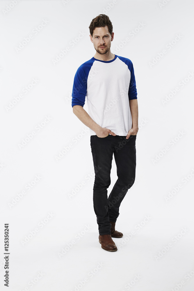 Serious dude standing against white background