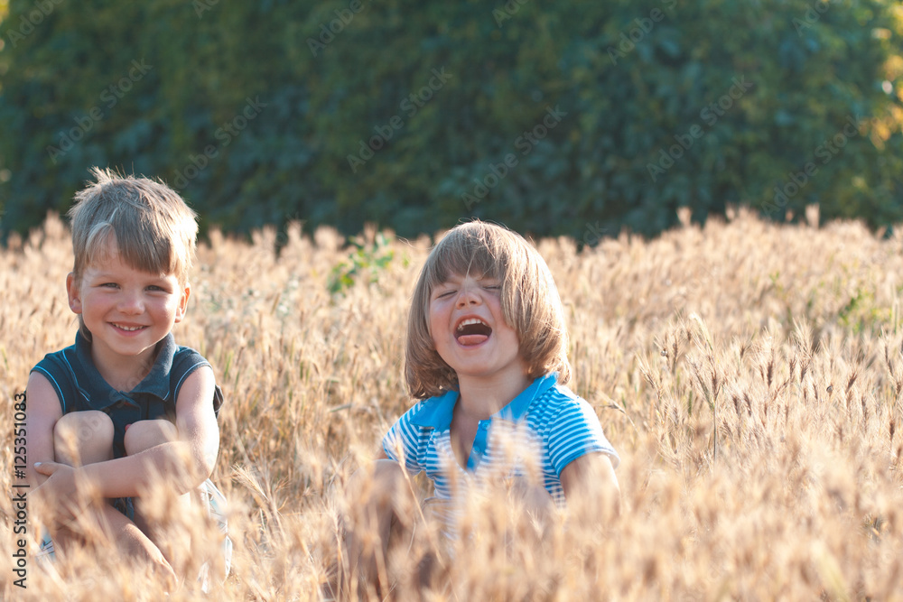 Joyful kids on the field in the summer