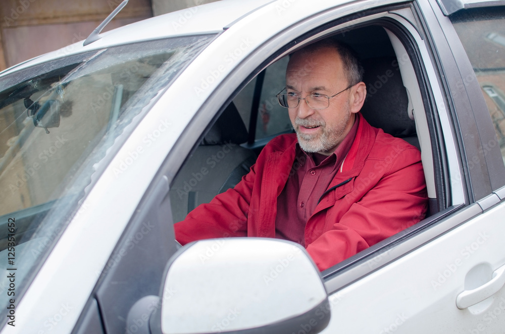 Aged man in the car Aged man in the car