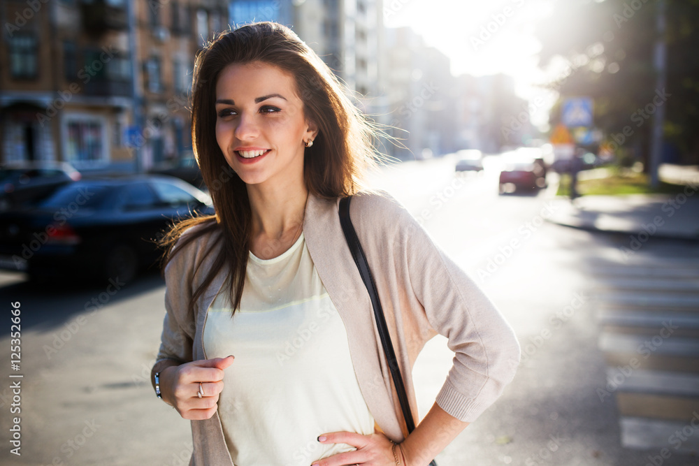 Portrait of beauty woman with perfect smile walking on the street and looking at camera