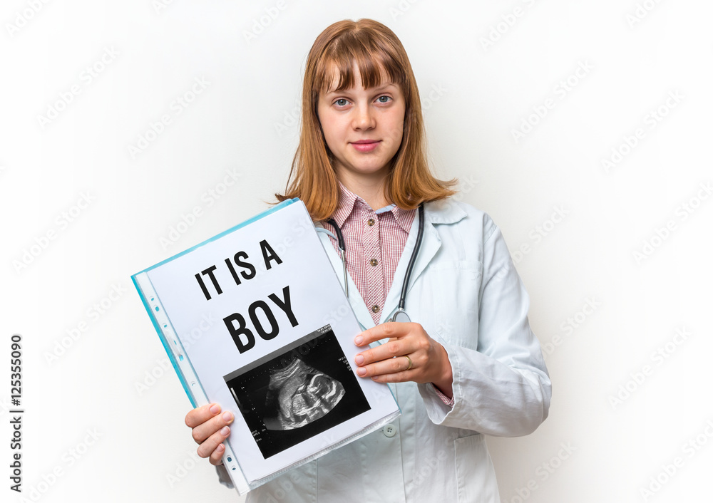 Doctor showing clipboard with written text: It is a Boy Doctor showing clipboard with written text: It is a Boy