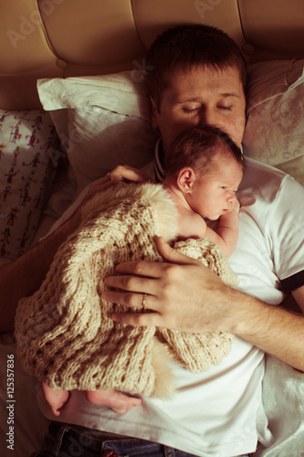 Happy father and his ewborn son photo