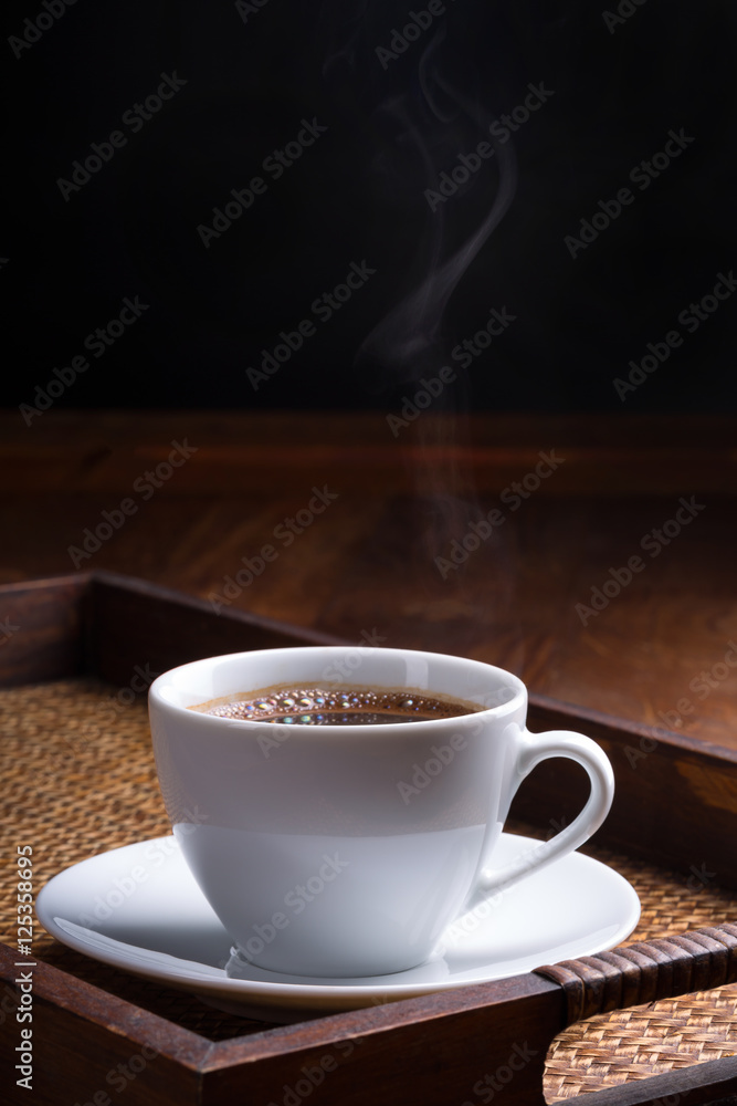 cup of hot coffee on dark background