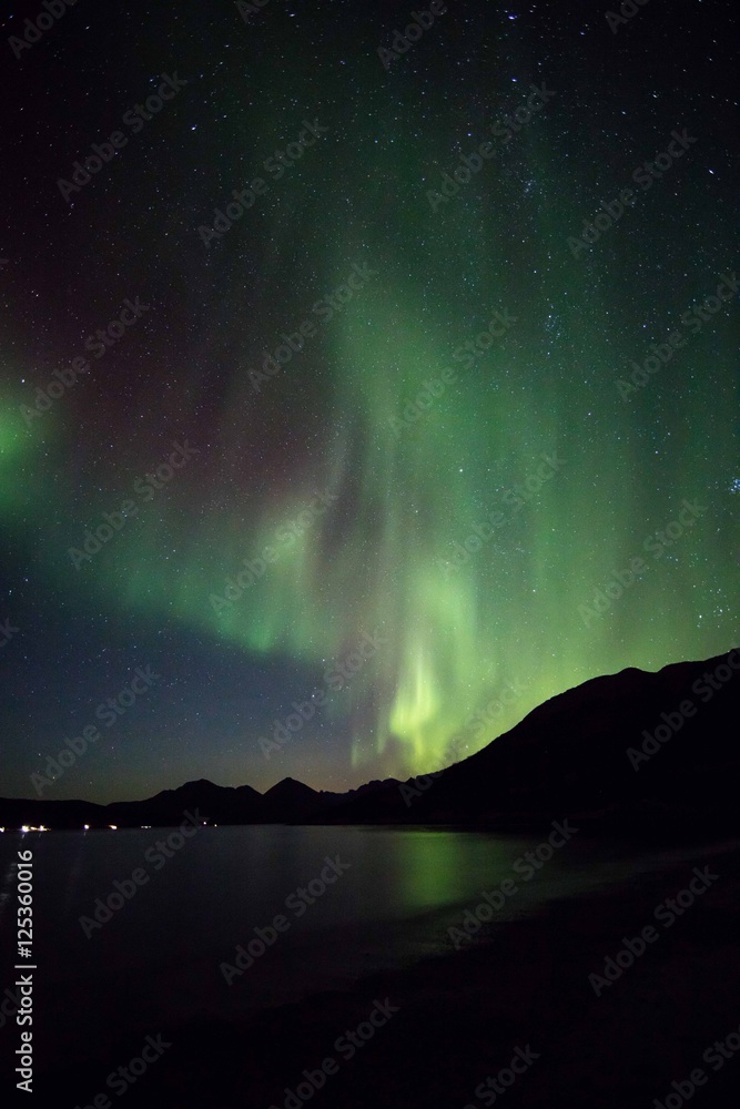 Aurora reflections over fjord waters