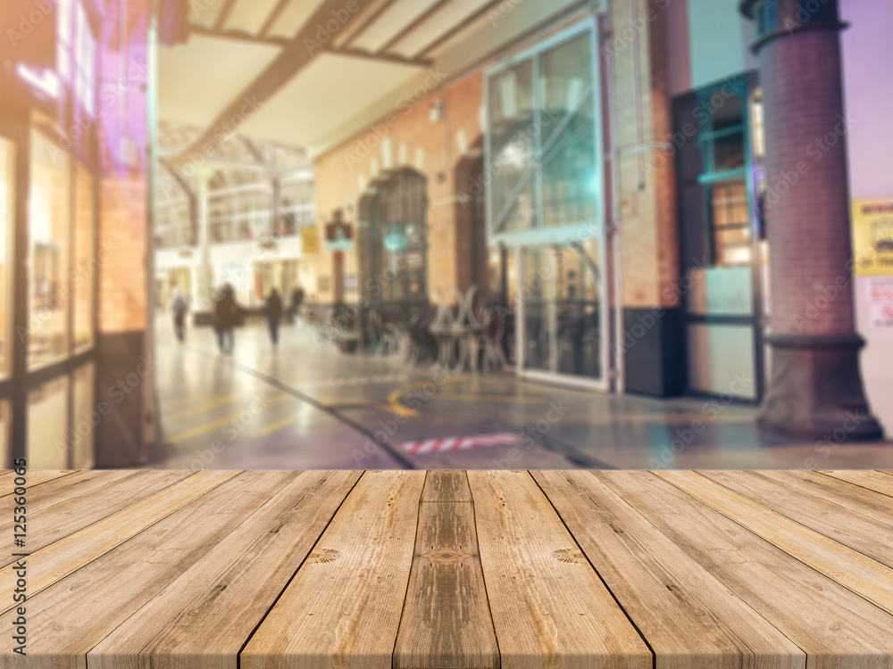 Wooden board empty table top on of blurred background. Perspective brown wood table over blur in street city night background - can be used mock up for montage products display or design visual layout Wooden board empty table top on of blurred background. Perspective brown wood table over blur in street city night background - can be used mock up for montage products display or design visual layout