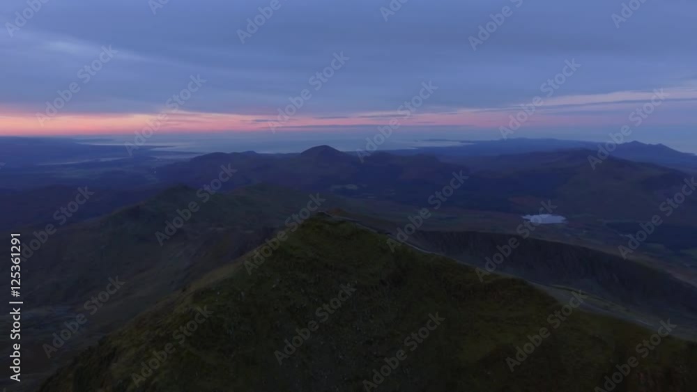 Descending aerial reveal of Mount Snowdon at sunrise. Descending aerial reveal of Mount Snowdon at sunrise.