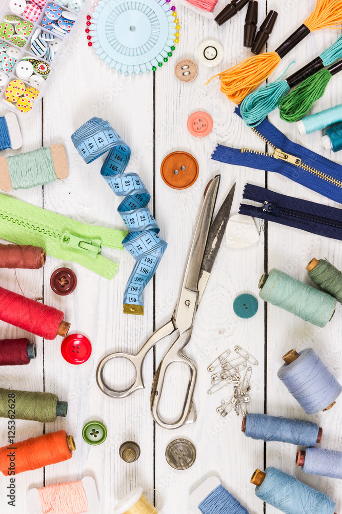Old scissors, buttons, threads, measuring tape and sewing suppli - obrazy, fototapety, plakaty 