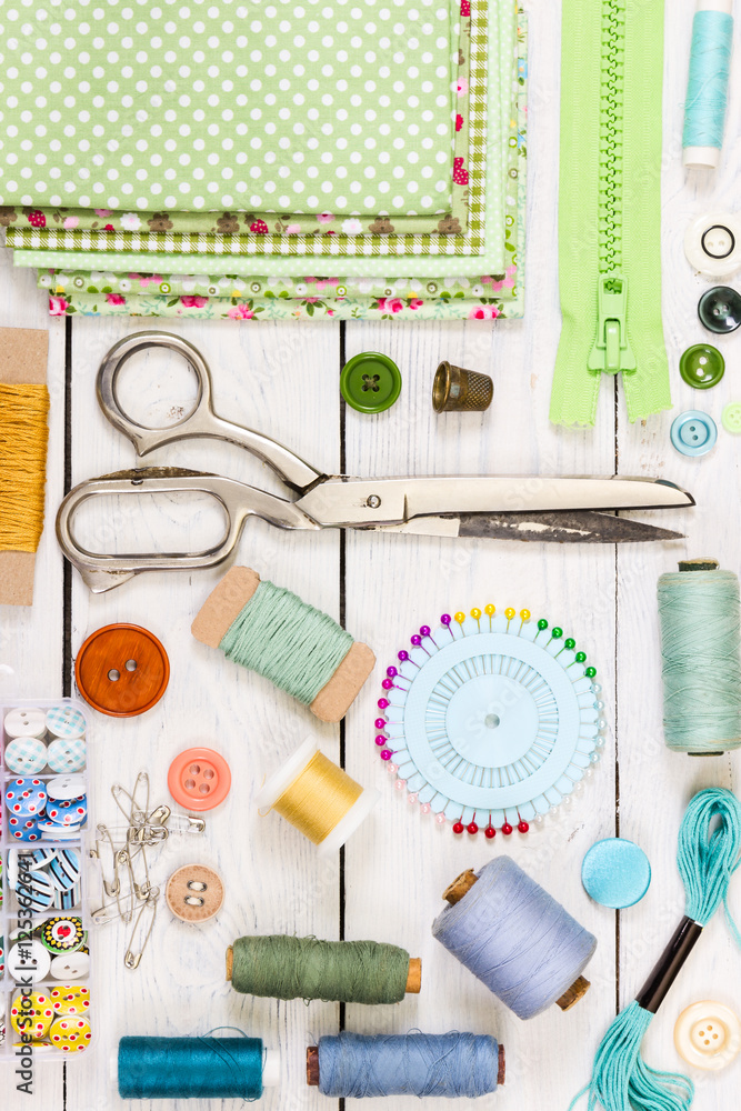 Tools for sewing on light wooden background. Top view. Tools for sewing on light wooden background. Top view.