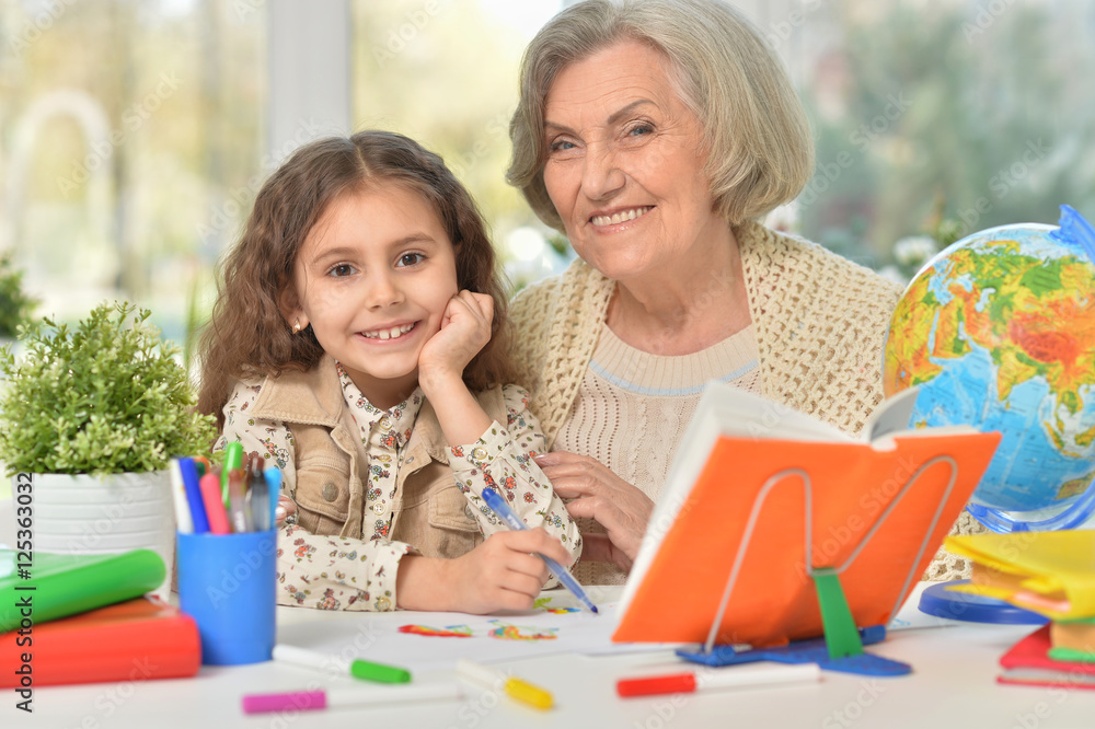 Grandmother with granddaughter drawing together Grandmother with granddaughter drawing together
