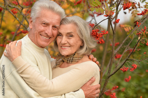 Portrait of a beautiful middle-aged couple in the autumn park