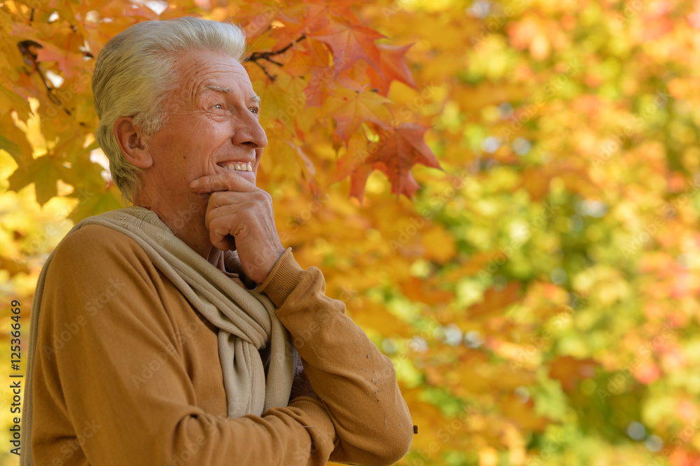 Smiling elderly man in autumn park Smiling elderly man in autumn park