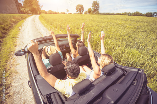 Group of best friends having fun at car trip  photo