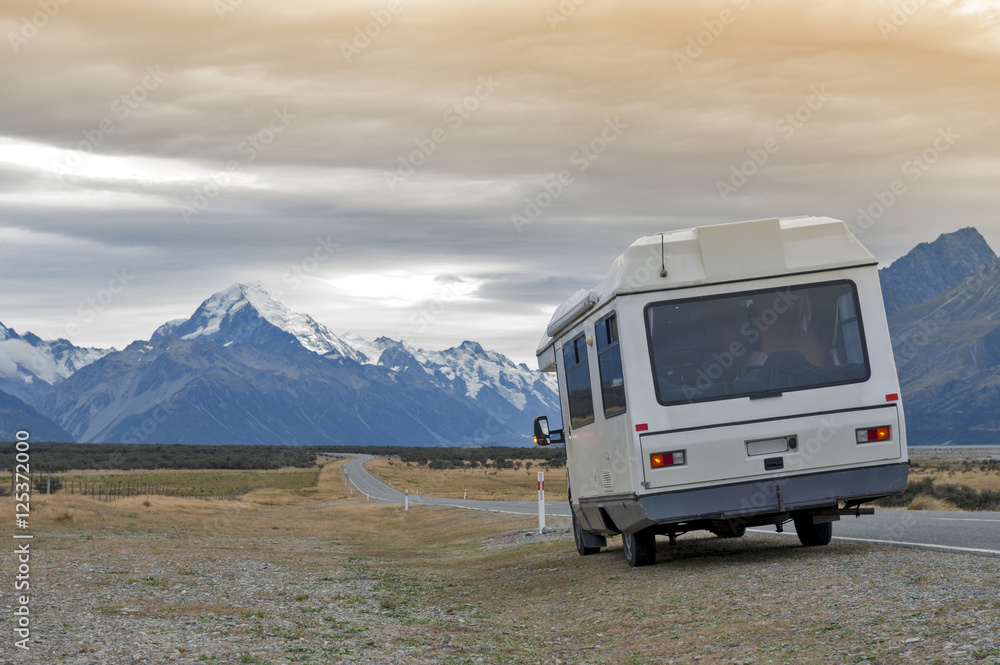Motorhome on Mount Cook Road (State Highway 80) along the Tasman River leading to Aoraki / Mount Cook National Park and the village Motorhome on Mount Cook Road (State Highway 80) along the Tasman River leading to Aoraki / Mount Cook National Park and the village