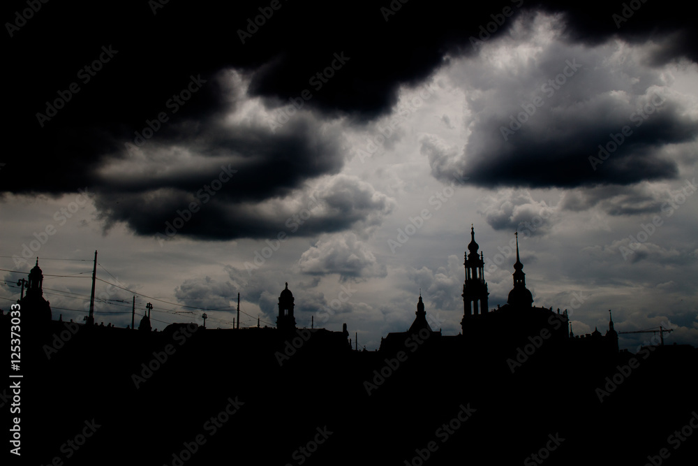 
Shadow siluette of the city skyline dresden with dark storm clouds 